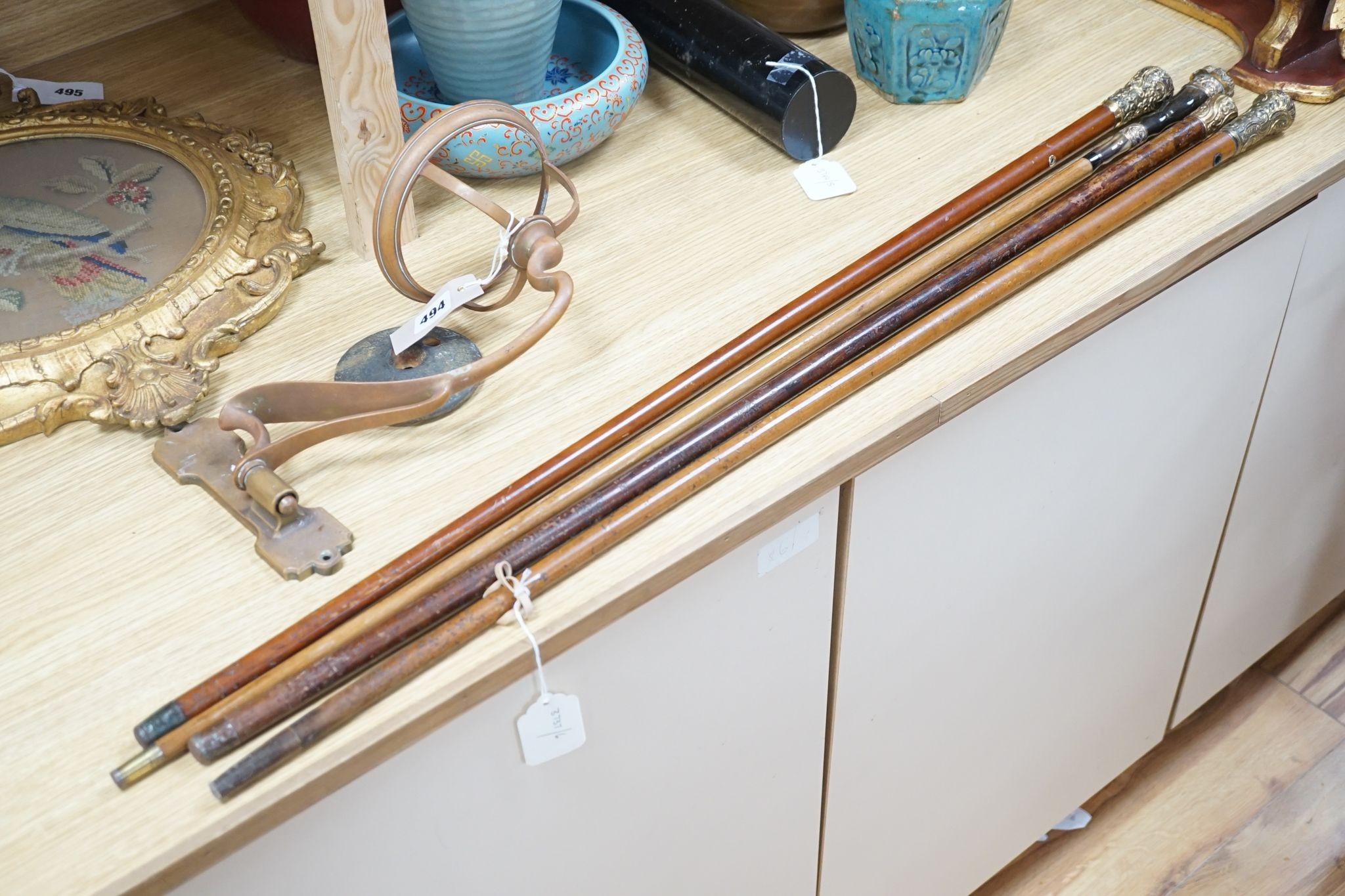 Four Victorian gilt-metal mounted walking canes, longest 97cm